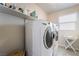 Modern laundry room featuring white appliances and folding table, offering convenience and efficiency for household chores at 151 Duckhook Ave, Las Vegas, NV 89148