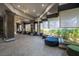 Relaxing lounge with plush seating, stylish lighting, and large windows overlooking lush greenery at 151 Duckhook Ave, Las Vegas, NV 89148