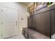 Mudroom featuring a built-in bench, storage, and decor, ideal for organization and style at 151 Duckhook Ave, Las Vegas, NV 89148