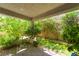 Covered patio showcasing lush greenery, brick flooring, and a serene outdoor living space at 151 Duckhook Ave, Las Vegas, NV 89148