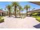 Resort-style pool area with mature palm trees and a brick-paved deck offering a vacation-like setting at 151 Duckhook Ave, Las Vegas, NV 89148