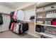 Organized walk-in closet featuring double hanging rods and built-in shelving, maximizing storage space at 151 Duckhook Ave, Las Vegas, NV 89148