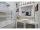 Elegant bathroom featuring a tub with shower, a vessel sink, and modern fixtures at 1604 Imperial Cup Dr, Las Vegas, NV 89117