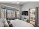 Bright bedroom featuring a cozy bed, a flat screen TV, and a view to the backyard at 1604 Imperial Cup Dr, Las Vegas, NV 89117