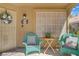 Cozy front porch with teal wicker chairs, creating a welcoming entry at 1604 Imperial Cup Dr, Las Vegas, NV 89117