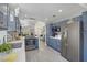 Modern kitchen featuring stainless steel appliances, white countertops, and stylish blue cabinetry at 1604 Imperial Cup Dr, Las Vegas, NV 89117