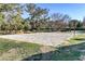 Outdoor sand volleyball court surrounded by green grass and mature trees at 1604 Imperial Cup Dr, Las Vegas, NV 89117