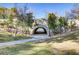 Stone archway over a paved path surrounded by trees and landscaping at 1604 Imperial Cup Dr, Las Vegas, NV 89117