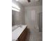 Bright bathroom featuring double sinks, a soaking tub, and a separate shower with neutral tile flooring at 1652 Black Fox Canyon Rd, Henderson, NV 89052