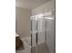Bright bathroom features a soaking tub and adjacent glass shower stall beneath shuttered windows at 1652 Black Fox Canyon Rd, Henderson, NV 89052