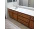 Bathroom vanity featuring double sinks with a white countertop and wooden cabinets at 1652 Black Fox Canyon Rd, Henderson, NV 89052
