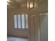 A bright bedroom with a window featuring white shutters at 1652 Black Fox Canyon Rd, Henderson, NV 89052