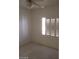 An airy bedroom with a ceiling fan and a window with white shutters at 1652 Black Fox Canyon Rd, Henderson, NV 89052