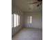 Spacious bedroom featuring a ceiling fan and dual shuttered windows at 1652 Black Fox Canyon Rd, Henderson, NV 89052