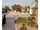 Residential street view with low-maintenance desert landscaping, shrubs and trees at 1652 Black Fox Canyon Rd, Henderson, NV 89052