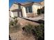 Exterior of a single-story home with a two-car garage and desert landscaping at 1652 Black Fox Canyon Rd, Henderson, NV 89052