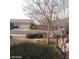 Residential street with rock landscaping, trees, shrubs, and well-maintained lawns at 1652 Black Fox Canyon Rd, Henderson, NV 89052