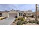 Charming single-story home with a well-manicured front yard and a two-car garage at 1652 Black Fox Canyon Rd, Henderson, NV 89052