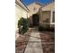 A welcoming covered entry leads to the home's front door with sidelight at 1652 Black Fox Canyon Rd, Henderson, NV 89052