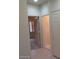 Hallway with tile flooring with views into another room through two open doorways at 1652 Black Fox Canyon Rd, Henderson, NV 89052