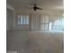 Bright living room with neutral carpet, ceiling fan, and shuttered windows offering ample natural light at 1652 Black Fox Canyon Rd, Henderson, NV 89052