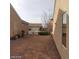 A spacious side yard with desert landscaping and a view of the neighborhood at 1652 Black Fox Canyon Rd, Henderson, NV 89052