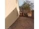 A side yard with desert landscaping featuring a mature tree and gated access at 1652 Black Fox Canyon Rd, Henderson, NV 89052