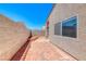 View of the backyard featuring a brick-paved patio, stucco walls, and low maintenance landscaping at 1717 Dwayne Stedman Ave, Las Vegas, NV 89106