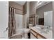Bright bathroom featuring a shower-tub combo and a single sink vanity with a large mirror at 1717 Dwayne Stedman Ave, Las Vegas, NV 89106