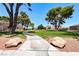 A pathway meanders through the common area showcasing lush greenery and mature trees for resident enjoyment at 1717 Dwayne Stedman Ave, Las Vegas, NV 89106