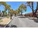 Gated community entrance with mature trees, landscaping, and secure access for residents and visitors at 1717 Dwayne Stedman Ave, Las Vegas, NV 89106