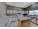 Bright kitchen with white cabinets, tile floors, and a center island at 1717 Dwayne Stedman Ave, Las Vegas, NV 89106