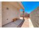 Outdoor patio with a bench, brick flooring, stucco walls, and a blue sky above at 1717 Dwayne Stedman Ave, Las Vegas, NV 89106