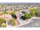 Aerial view of a single-Gathering home featuring a tile roof, desert landscaping, and a paved driveway at 1727 Sonoran Bluff Ave, Henderson, NV 89014
