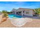 Gorgeous backyard featuring a sparkling pool, rock accents, and lush greenery, perfect for entertaining at 1727 Sonoran Bluff Ave, Henderson, NV 89014