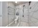 A modern bathroom featuring a tile shower, toilet and heated towel rack at 1727 Sonoran Bluff Ave, Henderson, NV 89014