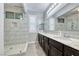 Modern bathroom with marble shower, dual sinks and sleek vanity lighting at 1727 Sonoran Bluff Ave, Henderson, NV 89014