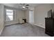 A bedroom featuring carpet flooring, fan, and a chair for relaxing at 1727 Sonoran Bluff Ave, Henderson, NV 89014