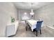 Stylish dining room featuring an elegant chandelier, white console table, and gray accent chairs at 1727 Sonoran Bluff Ave, Henderson, NV 89014