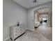 Spacious entryway featuring gray tile floors, arched doorways, and elegant decorative furniture at 1727 Sonoran Bluff Ave, Henderson, NV 89014