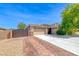 Lovely home showcasing a two-car garage, brick driveway, gated RV parking, and mature landscaping at 1727 Sonoran Bluff Ave, Henderson, NV 89014