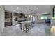 Open kitchen featuring stainless steel appliances, large island with seating, and modern lighting at 1727 Sonoran Bluff Ave, Henderson, NV 89014
