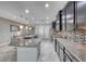 Bright kitchen showcasing a granite island, stainless appliances, dark wood cabinets, and tile backsplash at 1727 Sonoran Bluff Ave, Henderson, NV 89014