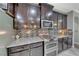 Detailed kitchen with stainless steel double oven, gas cooktop, mosaic backsplash, and granite countertops at 1727 Sonoran Bluff Ave, Henderson, NV 89014