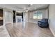 Cozy living room featuring hardwood floors, a modern fireplace, and a comfortable blue armchair at 1727 Sonoran Bluff Ave, Henderson, NV 89014