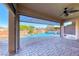 Beautiful outdoor patio with ceiling fan overlooking a luxurious pool and landscaped backyard at 1727 Sonoran Bluff Ave, Henderson, NV 89014