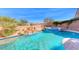 Beautiful pool with a rock waterfall feature and a spa, offering a serene outdoor experience at 1727 Sonoran Bluff Ave, Henderson, NV 89014