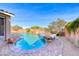Inviting pool with rock waterfall and spa, surrounded by lush greenery and a brick-paved deck at 1727 Sonoran Bluff Ave, Henderson, NV 89014