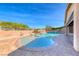Tranquil pool with a rock waterfall and spa, complemented by well-maintained landscaping at 1727 Sonoran Bluff Ave, Henderson, NV 89014
