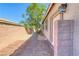 Charming side yard featuring stone pavers and lush foliage creating a private outdoor space at 1727 Sonoran Bluff Ave, Henderson, NV 89014